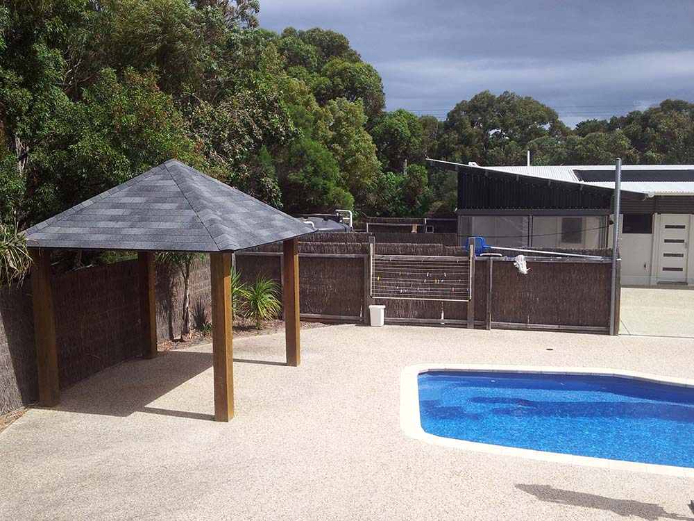 Poolside cabana with shingle roof in Perth