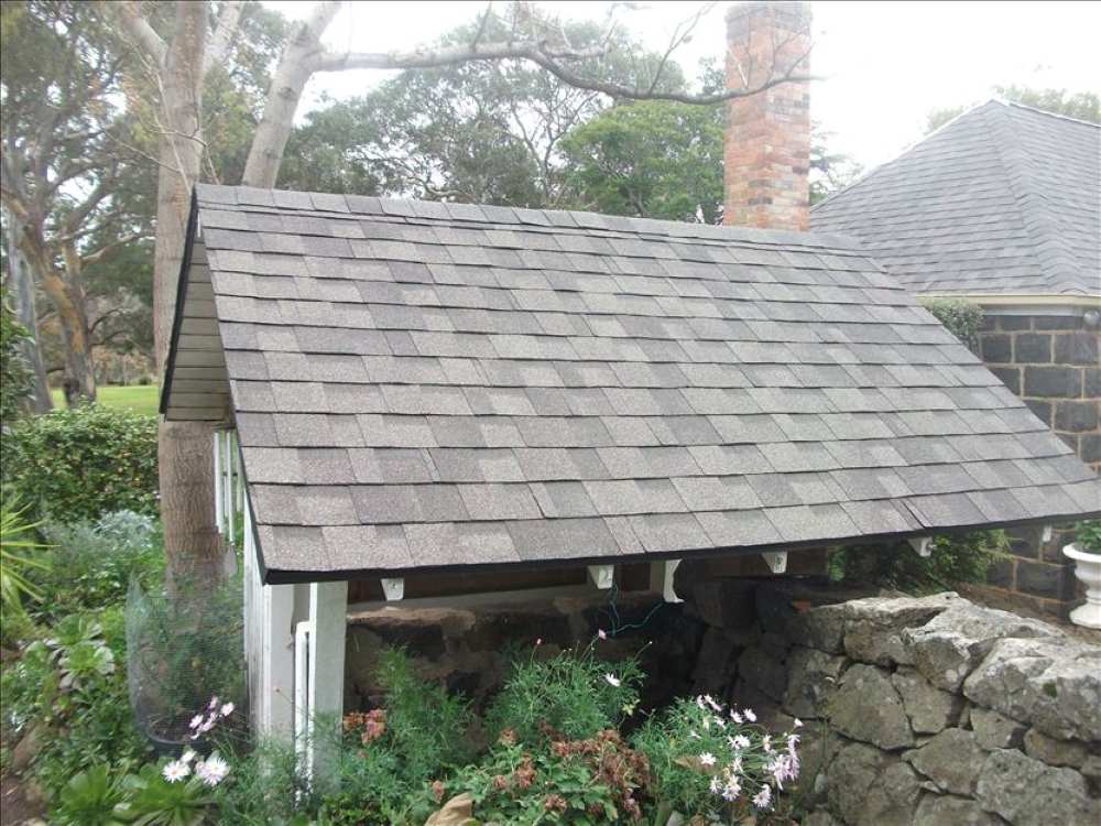 Roofed pergola with asphalt shingles in Perth garden