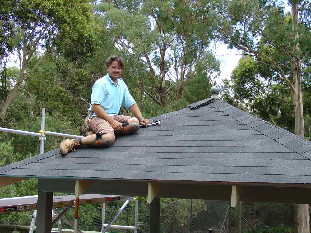 Completed ridge capping on asphalt shingle roof