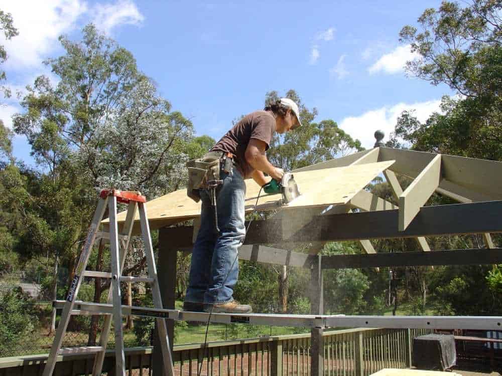 Cutting Plywood on Trusses circular saw Cutting 12mm structural plywood sheets on gazebo roof trusses with circular saw - DIY roof deck preparation