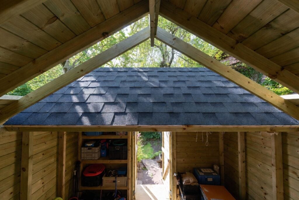 Shed Kits With Premium Shingle Roofs 6 Interior view under dual black shingle roof inside a garden shed showing cool shaded space