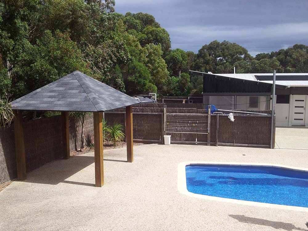 Outdoor Gazebos Australia 27 Poolside wooden gazebo with grey shingle roof next to swimming pool in melbourne backyard