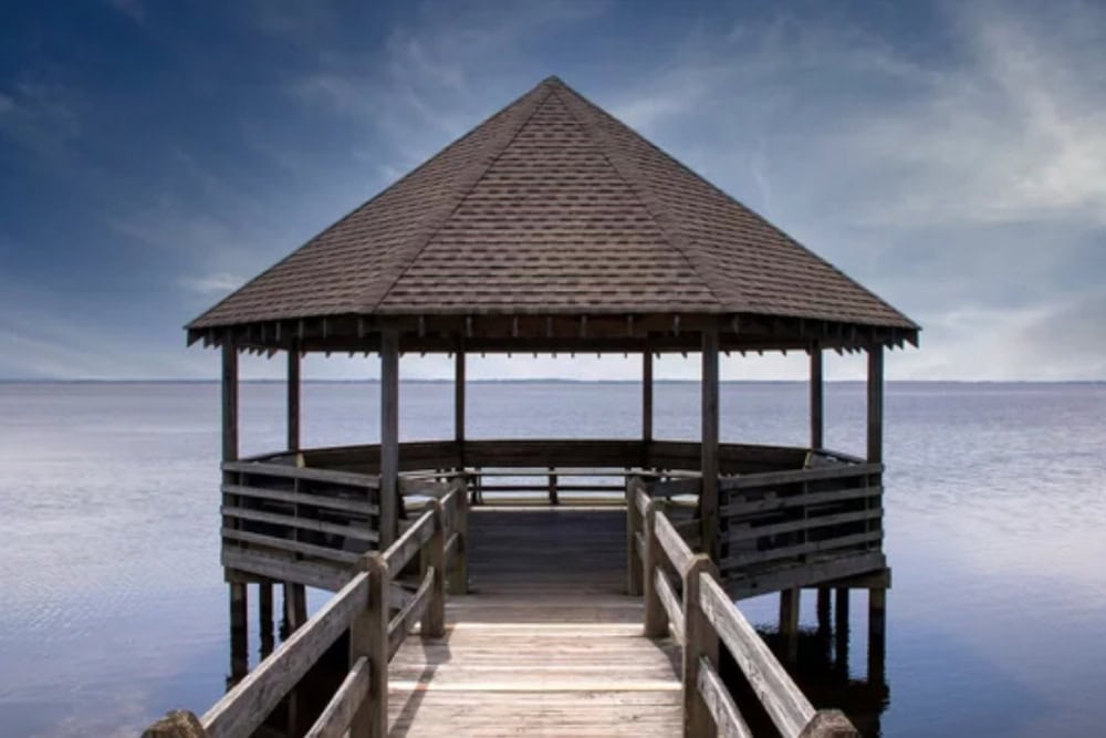 Outdoor Gazebos Australia 16 Rust-free hexagonal seaside gazebo with driftwood laminated asphalt shingles on a wooden pier over calm water, perfect coastal durable roofing solution